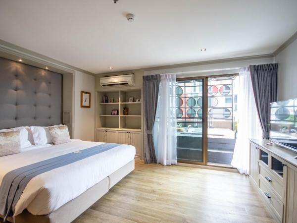 THEA Serviced Apartment by TH District : photo 2 de la chambre suite 2 chambres avec bain à remous