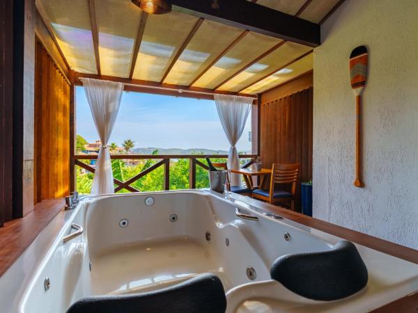 Pousada Santorini : photo 1 de la chambre chambre double avec baignoire spa