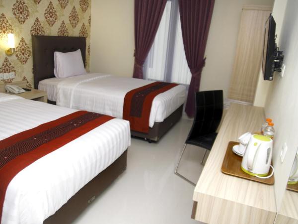 Hersya Front One Inn Surabaya : photo 1 de la chambre chambre lits jumeaux deluxe
