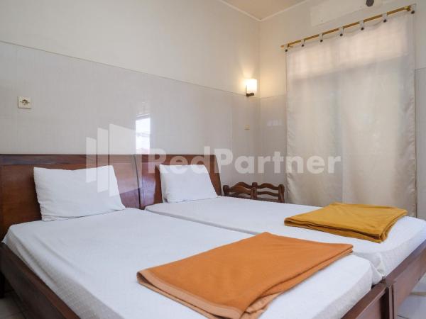 Wisma Garuda Syariah Condoongcatur Mitra RedDoorz : photo 7 de la chambre chambre lits jumeaux standard