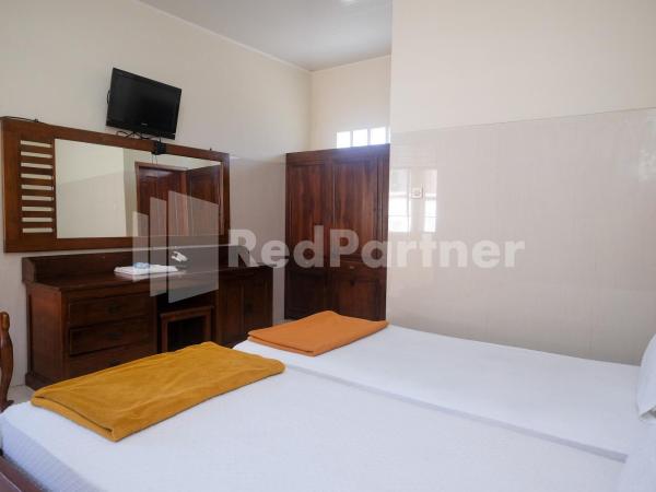 Wisma Garuda Syariah Condoongcatur Mitra RedDoorz : photo 8 de la chambre chambre lits jumeaux standard