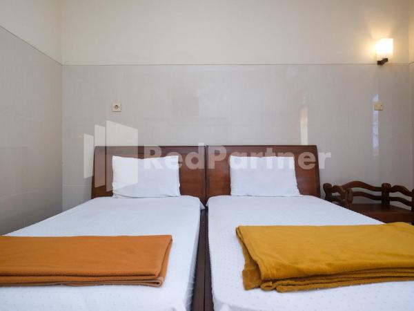 Wisma Garuda Syariah Condoongcatur Mitra RedDoorz : photo 1 de la chambre chambre lits jumeaux standard