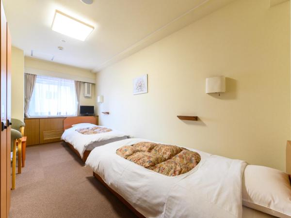 Sapporo International Youth Hostel : photo 1 de la chambre chambre lits jumeaux avec salle de bains et toilettes communes