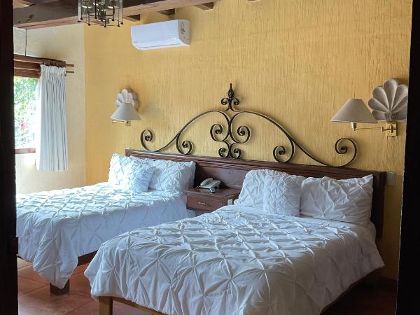 Villa San Jose Hotel & Suites : photo 1 de la chambre chambre double de luxe avec 2 lits doubles et vue sur le jardin