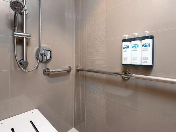 Hyatt House Orlando Airport : photo 3 de la chambre chambre lit king-size avec douche accessible en fauteuil roulant den - accessible aux personnes à mobilité réduite