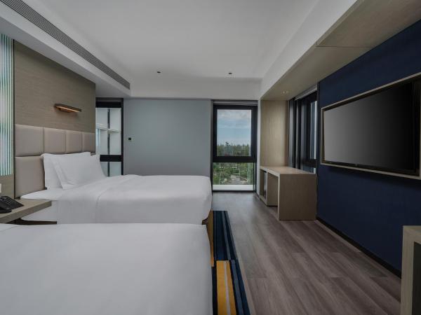 Sanya Haitang Bay Moutai Resort Boutique Hotel : photo 1 de la chambre chambre lits jumeaux - vue sur jardin 