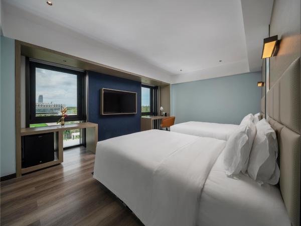 Sanya Haitang Bay Moutai Resort Boutique Hotel : photo 2 de la chambre chambre lits jumeaux - vue sur jardin 