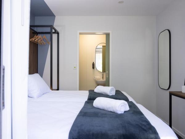 Haka House Rotorua : photo 3 de la chambre chambre lits jumeaux avec salle de bains privative