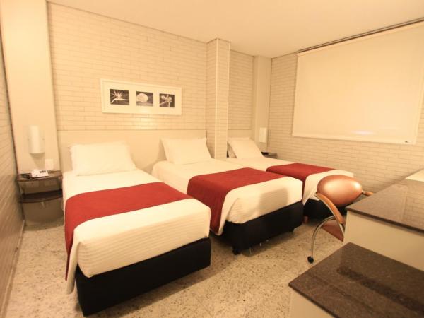 Hotel Confiance Batel : photo 1 de la chambre chambre triple de luxe avec 3 lits simples 