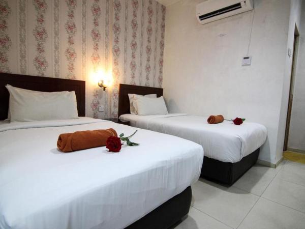Rose Cottage Hotel Taman Perling : photo 1 de la chambre chambre lits jumeaux