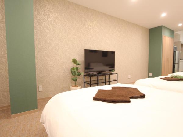 LUANAHOTEL IN KOUENJI : photo 4 de la chambre suite familiale