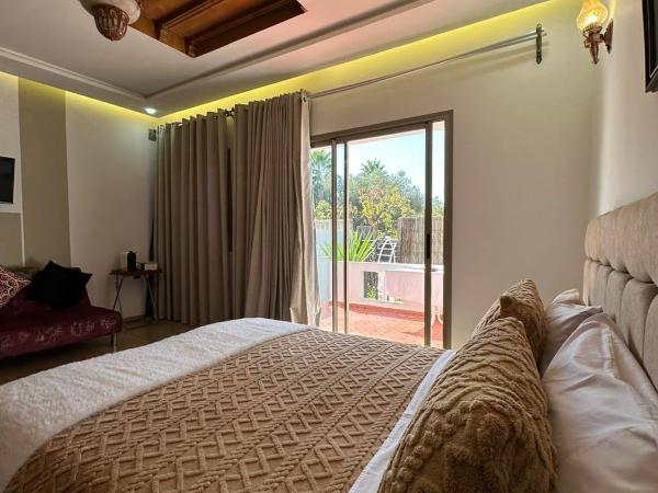 Maison d'hôtes La Ferme AZIZA : photo 1 de la chambre bungalow - vue sur jardin