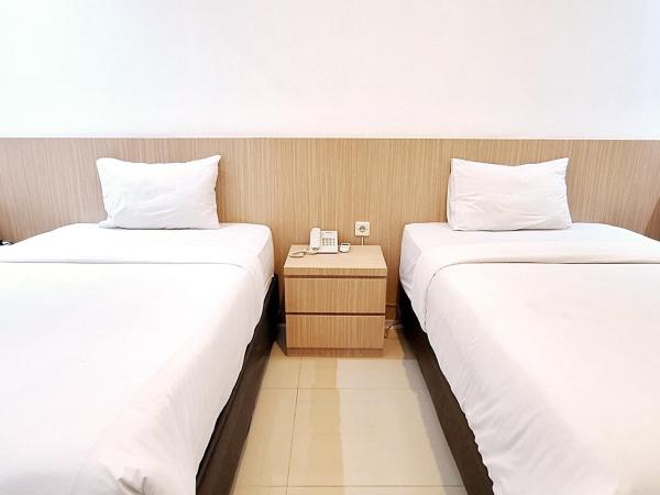 Urbanview Hotel Syariah Hapsari YIA : photo 5 de la chambre chambre lits jumeaux deluxe