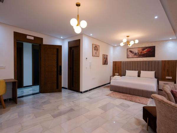 IMMOKA SUITEs : photo 6 de la chambre suite deluxe avec lit king-size