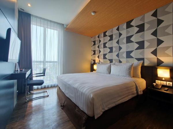 Luminor Hotel Jemursari By WH : photo 1 de la chambre chambre deluxe double ou lits jumeaux