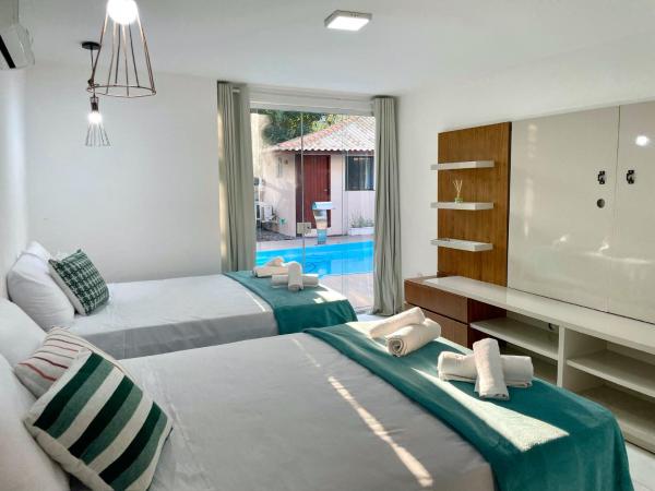 Do Adriano Suites : photo 1 de la chambre chambre avec 2 grands lits queen-size