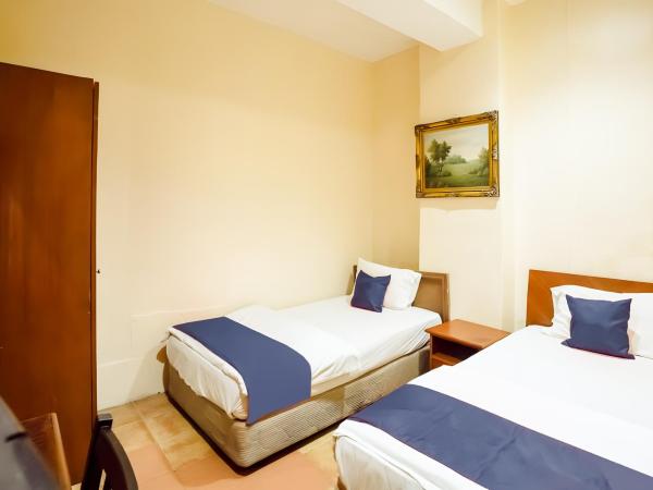 New Casavilla Travellers Lodge Pudu : photo 1 de la chambre chambre lits jumeaux