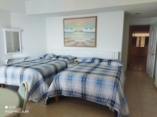 Playa Dorada Condominio Torres Gemelas : photo 1 de la chambre chambre lits jumeaux avec balcon