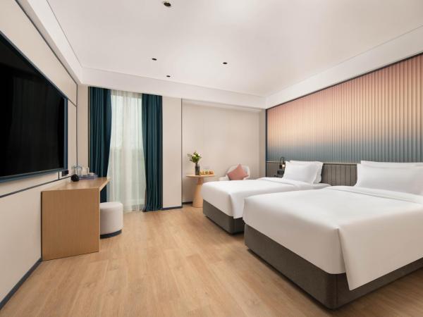 广州番禺万博中心舒与酒店 : photo 1 de la chambre chambre lits jumeaux spacieuse