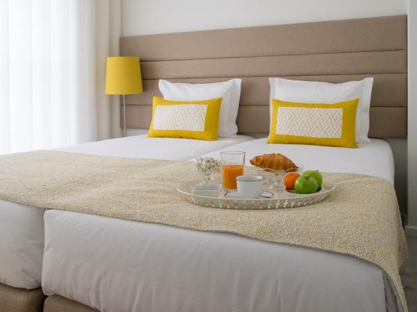 Simon Guest Apartments : photo 1 de la chambre chambre double ou lits jumeaux avec terrasse