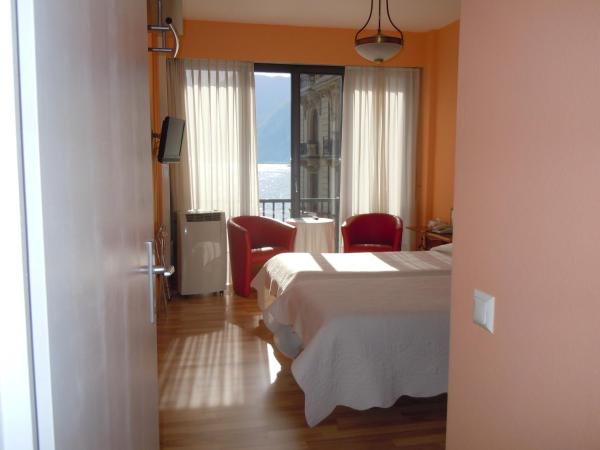 Swiss Lodge Nassa Garni : photo 1 de la chambre chambre lits jumeaux standard - vue sur lac
