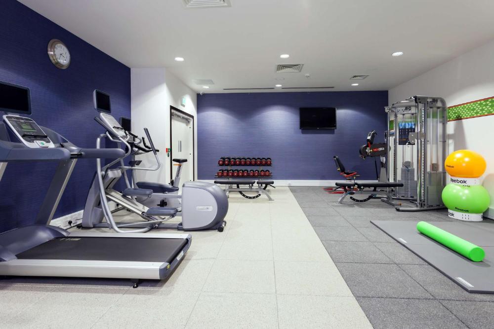 Fitness room with treadmills, exercise machines, and weights at Hampton by Hilton London Waterloo