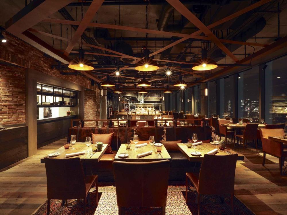 Restaurant with tables and chairs at Novotel London Canary Wharf
