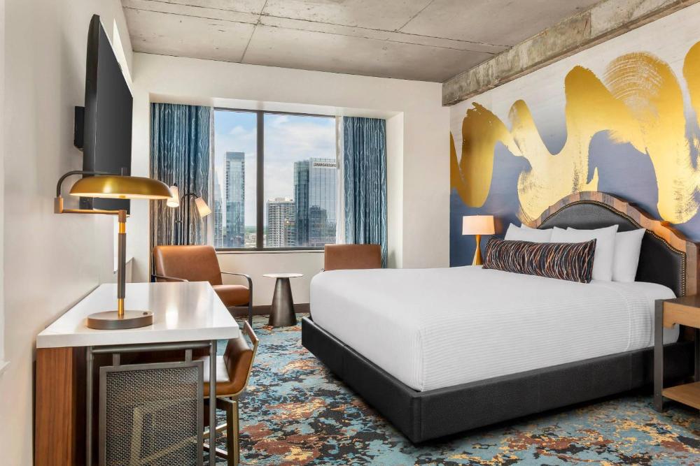 Guest room with a bed, desk, chair, and window at Cambria Hotel Nashville Downtown
