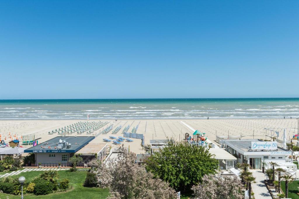 vue aérienne d'une plage avec un complexe hôtelier et l'océan dans l'établissement Kiss Beachfront Hotel & Restaurant, à Cervia
