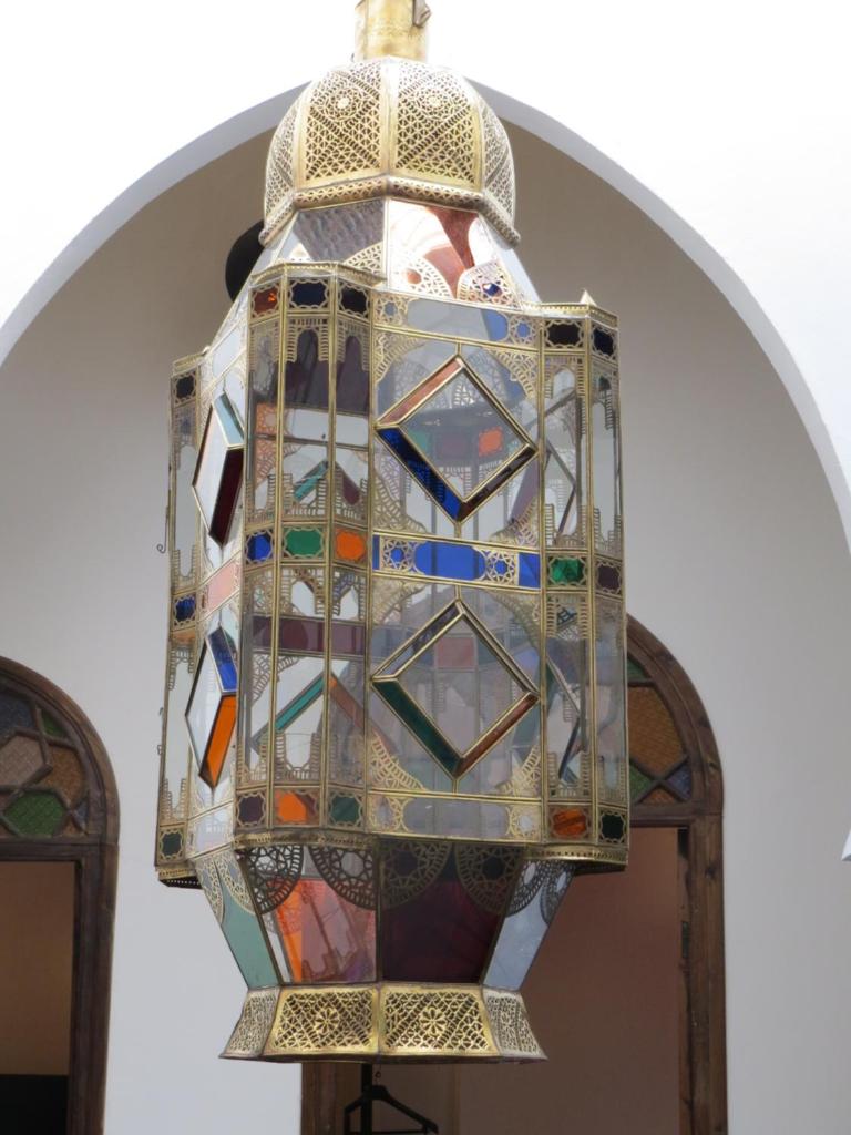 un lustre en verre teinté suspendu au plafond dans l'établissement Riad Arous Chamel, à Tanger 27 autres photos