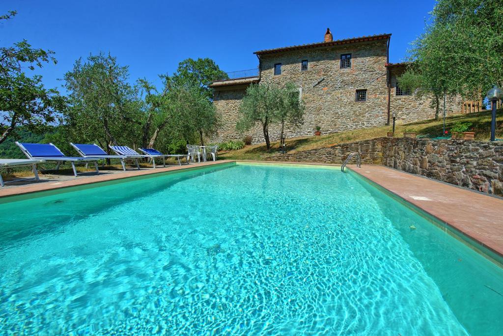 une piscine devant un immeuble dans l'établissement Villa Poggio Conca by PosarelliVillas, à Incisa in Valdarno