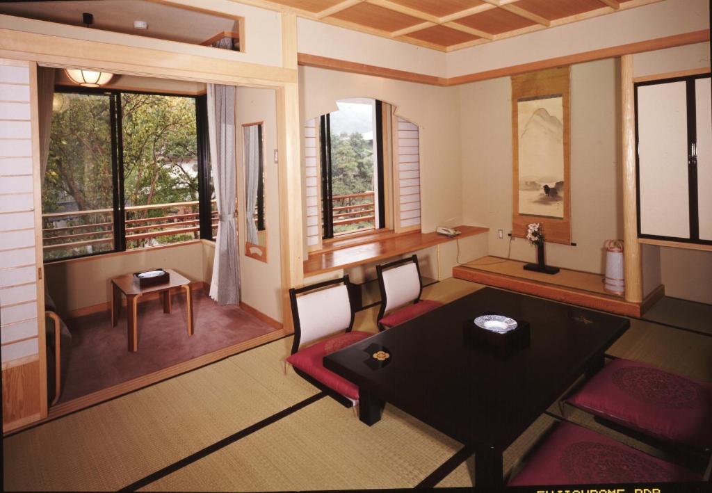 une pièce avec une table, des chaises et des fenêtres dans l'établissement Yanagiya, à Kōfu 37 autres photos