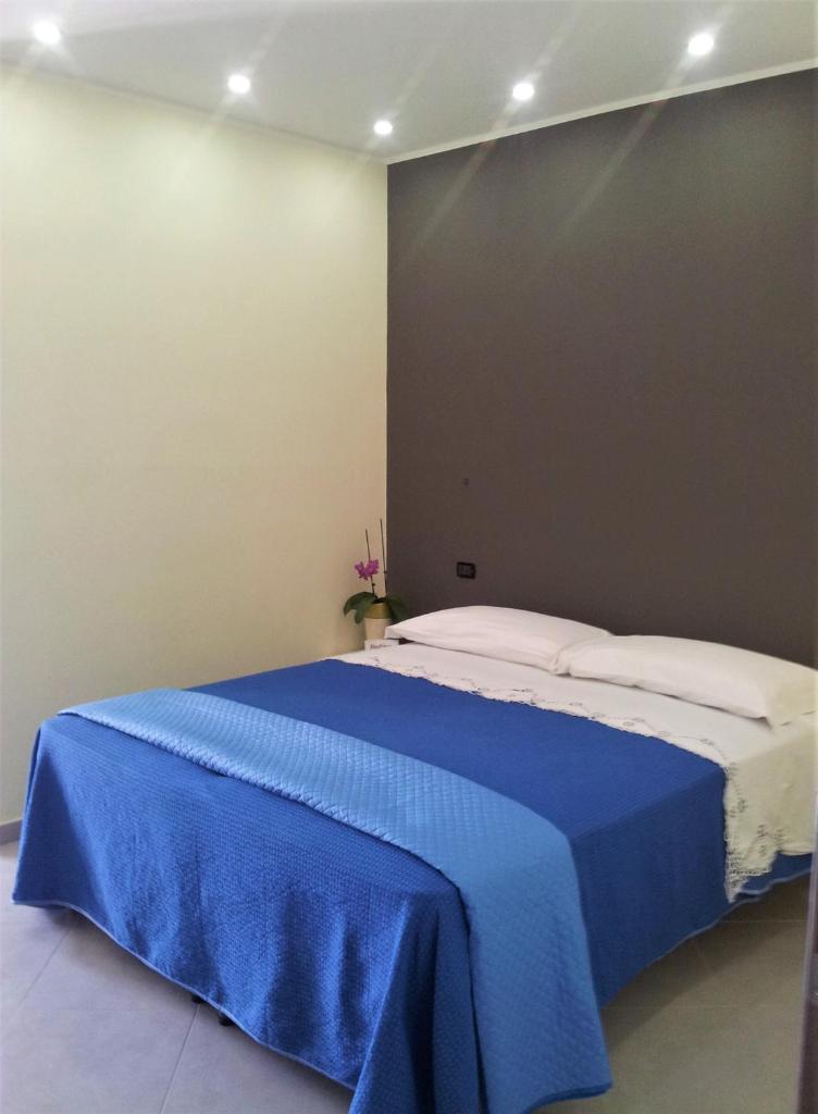 - une chambre avec un lit doté d'une couverture bleue dans l'établissement Hotel Rodian, à Acquappesa