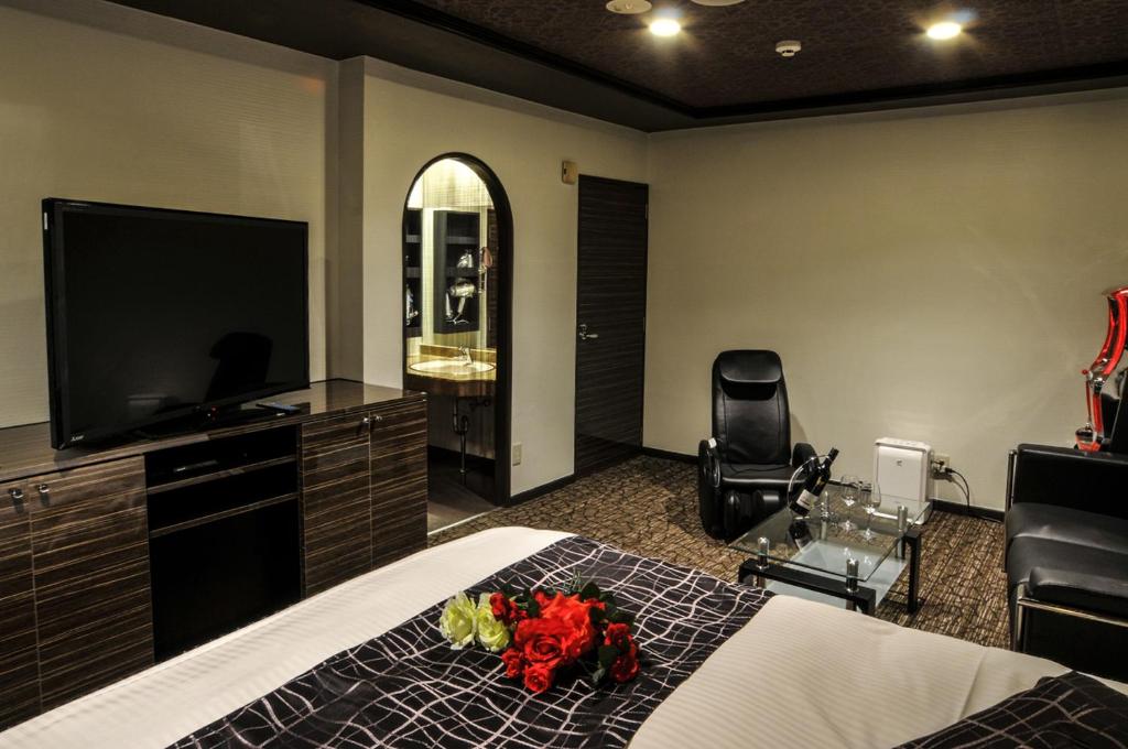 une chambre avec un lit et une télévision à écran plat dans l'établissement Hotel Grande (Love Hotel), à Kitakyūshū 6 autres photos