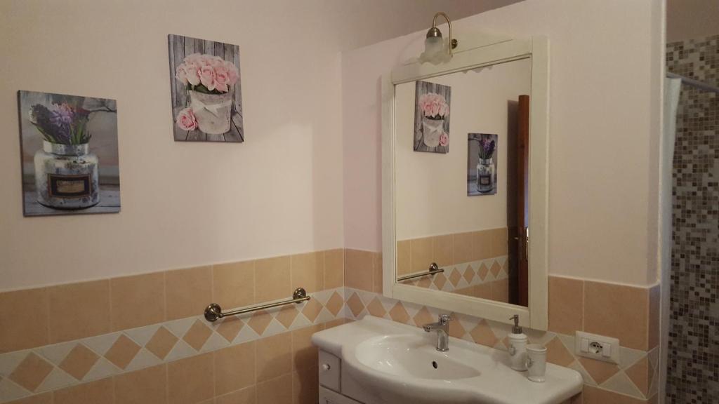 une salle de bain avec un lavabo et un miroir dans l'établissement Villa Rosi, à Capitana