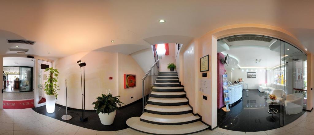 un couloir avec un escalier en colimaçon dans un bâtiment dans l'établissement Hotel Savoia, à Lignano Sabbiadoro