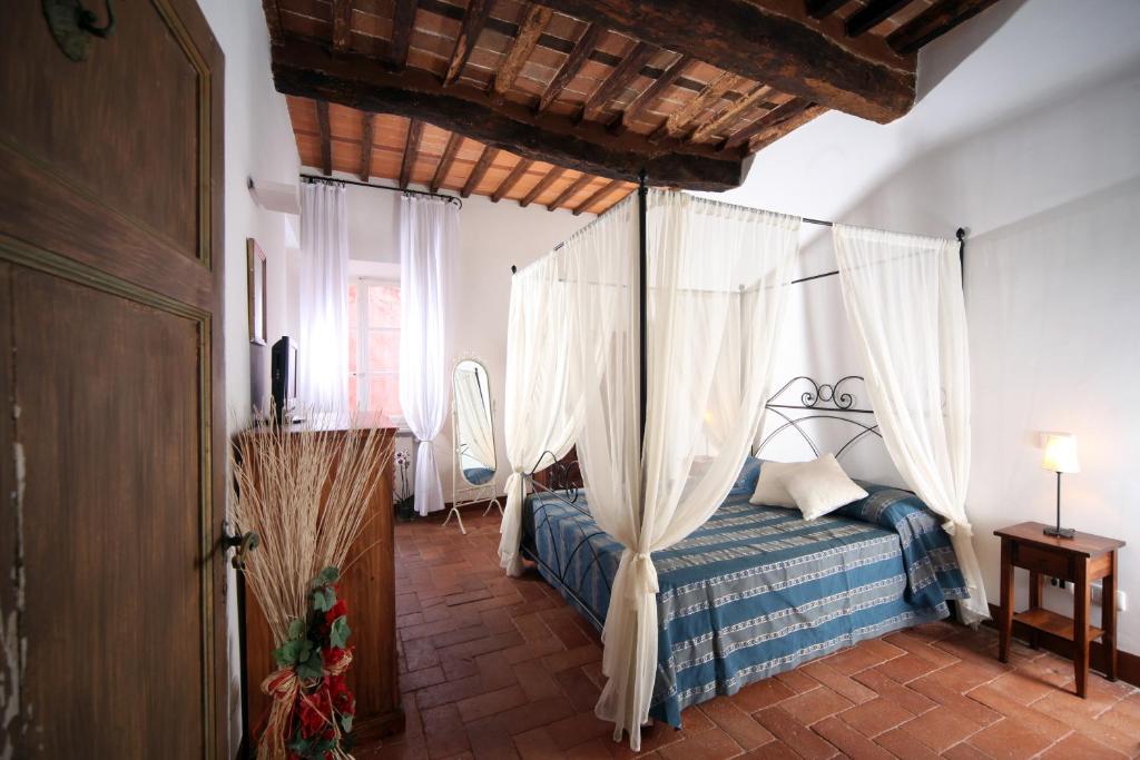 une chambre avec un lit à baldaquin dans l'établissement Villa Lorien, à Massarosa