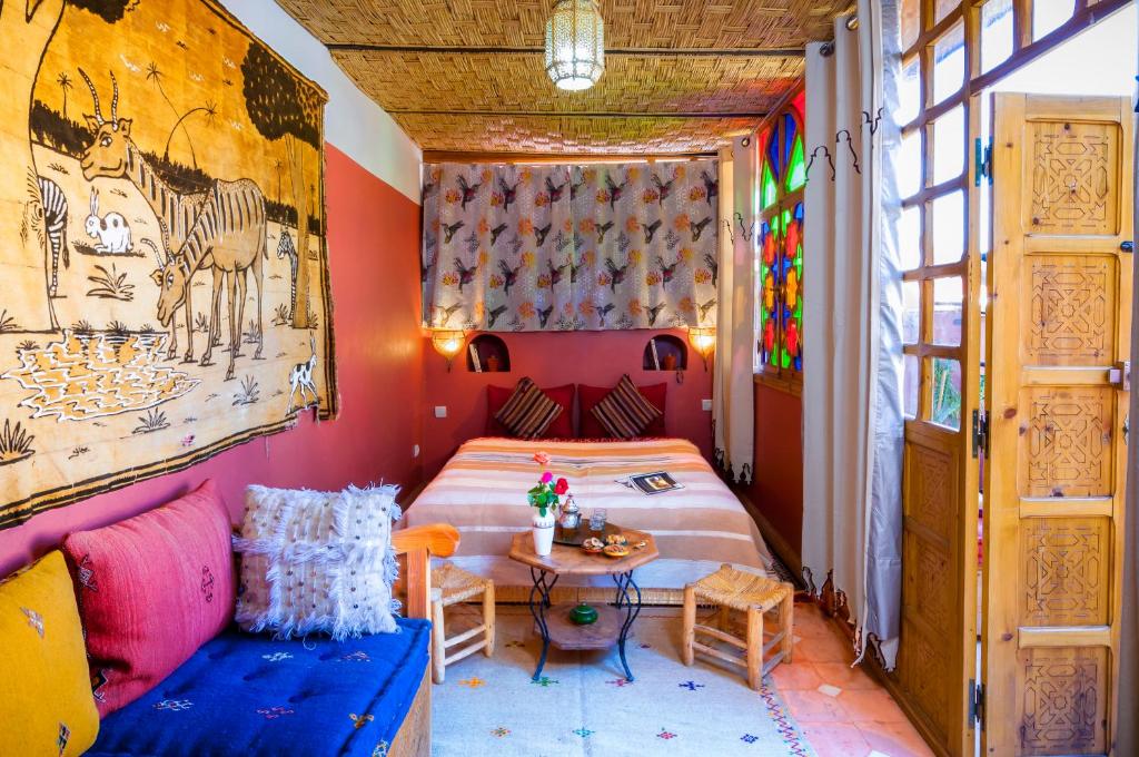 une chambre avec un lit et une table dans une pièce dans l'établissement Riad Dar Jdati, à Marrakech