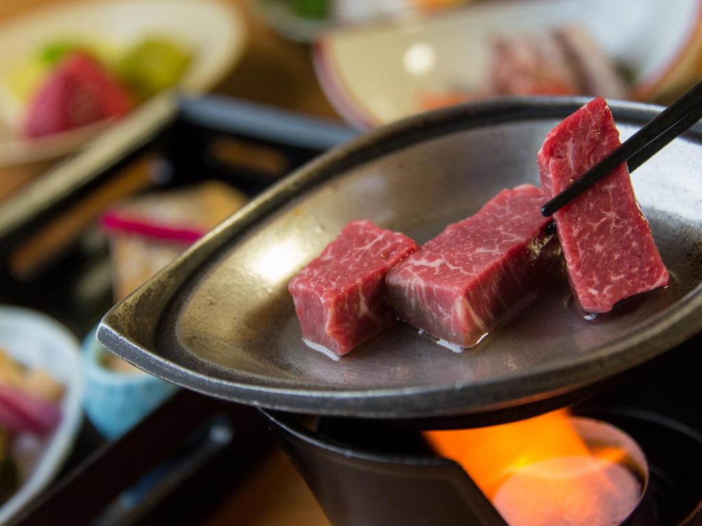 une assiette avec quatre morceaux de viande sur une cuisinière dans l'établissement Arima Onsen Motoyu Ryuusenkaku, à Kobe 83 autres photos
