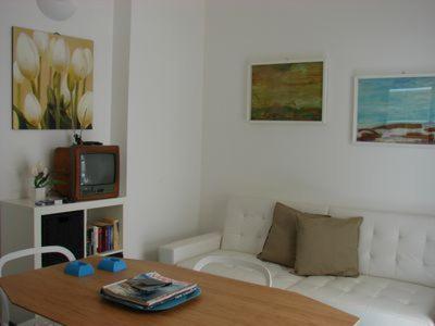 un salon avec une table et une télévision dans l'établissement Villa Alice, à Santo Stefano di Camastra