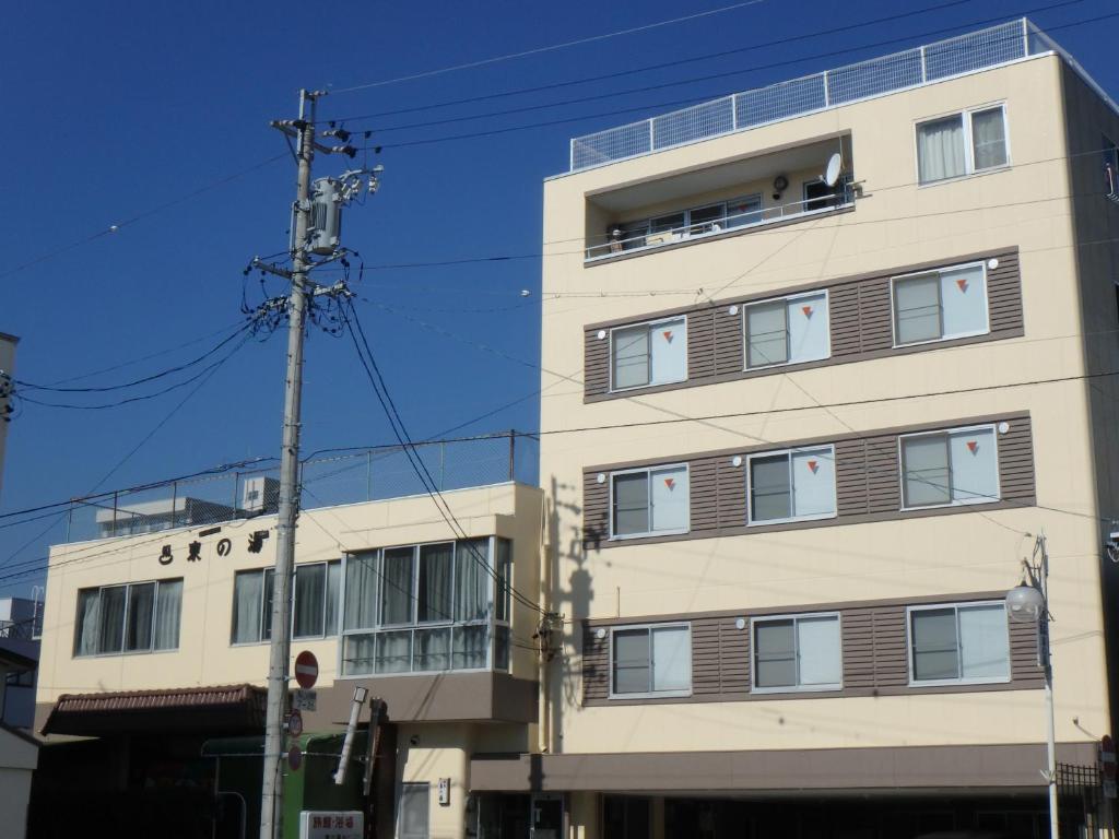 un grand bâtiment avec des fenêtres sur le côté dans l'établissement Azuma no Yu, à Nagano 25 autres photos