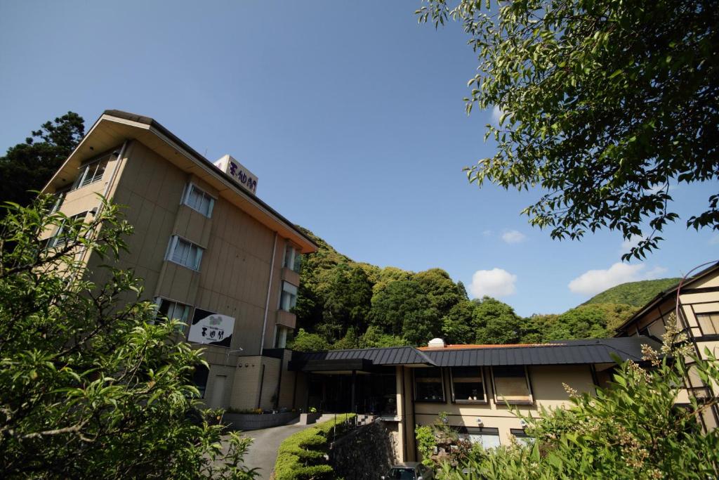 un hôtel avec une montagne en arrière-plan dans l'établissement Gyokusenkaku, à Nagato