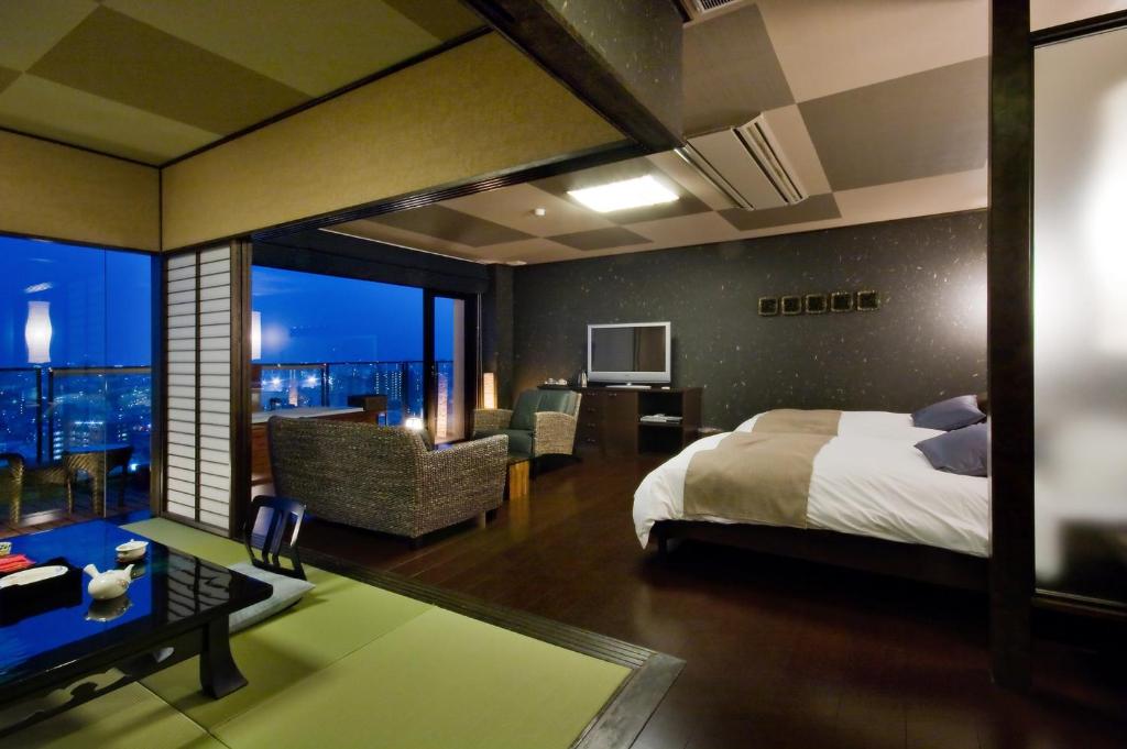 une chambre avec un lit et un salon dans l'établissement Yunaginoyu Hotel Hanajyukai, à Takamatsu