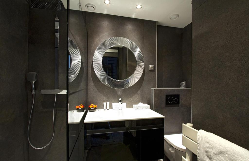 une salle de bain avec un lavabo et un miroir dans l'établissement Hotel Les Mélèzes, à Les Deux Alpes