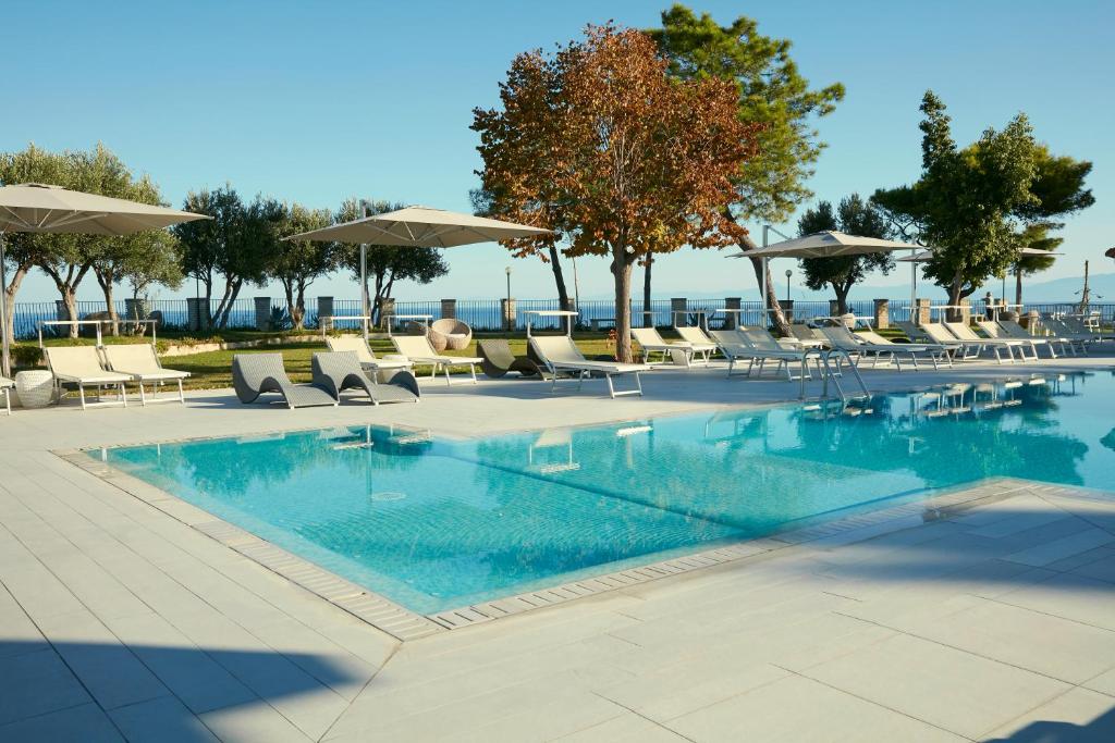 une piscine avec chaises et parasols dans l'établissement TUI BLUE Tropea, à Santa Domenica 56 autres photos