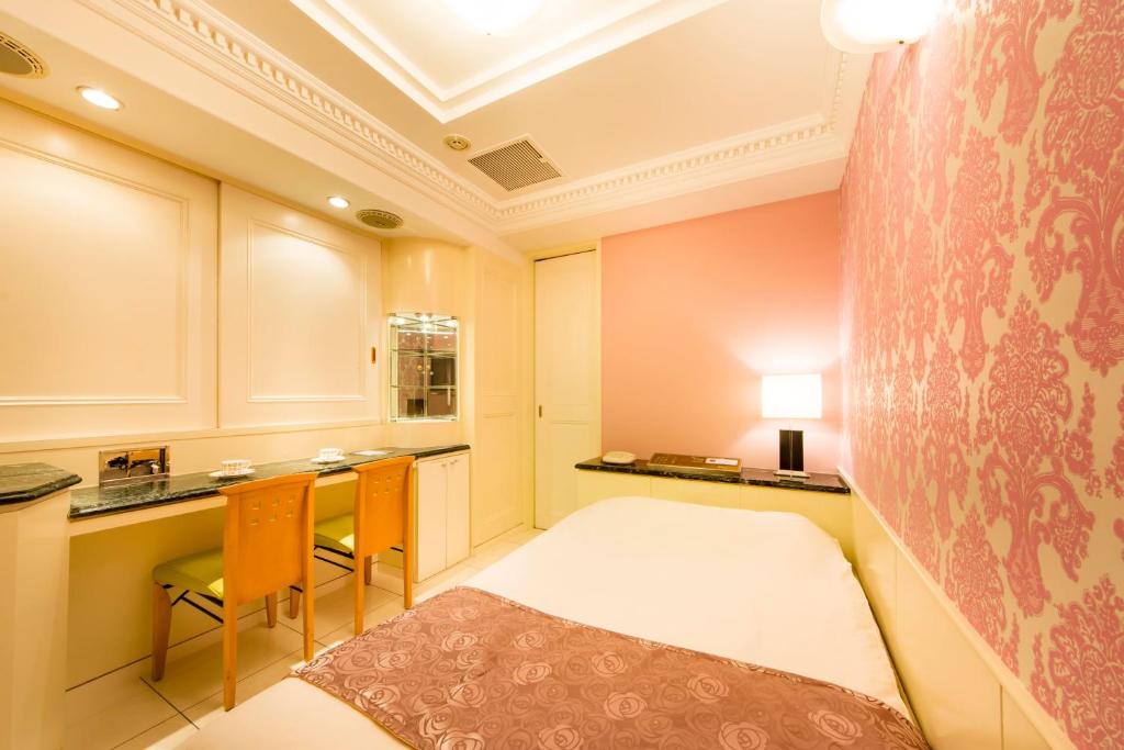 une chambre avec un lit, une table et des chaises dans l'établissement Hotel Apio, à Tokyo
