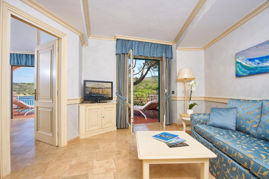 un salon avec un canapé et une télévision dans l'établissement Hotel Hermitage, à Portoferraio