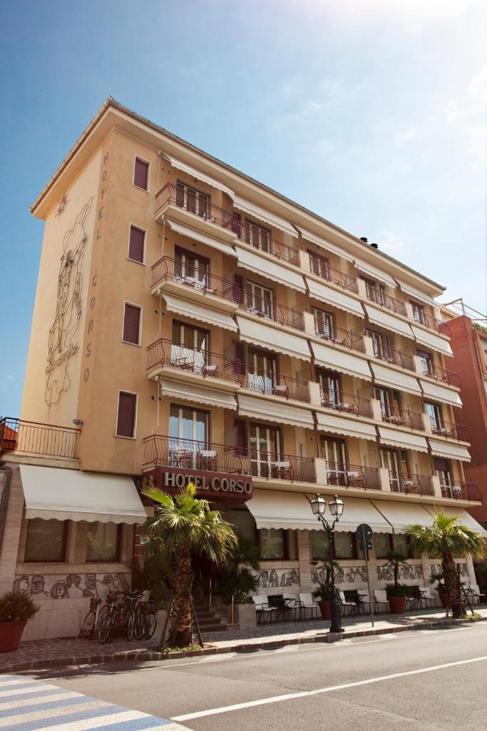 un grand immeuble situé sur le côté d'une rue dans l'établissement Hotel Corso Alaxi Hotels, à Alassio