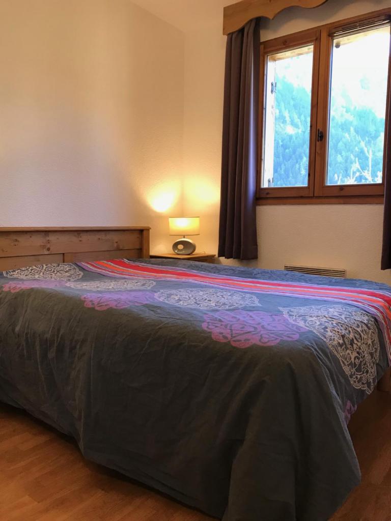 un grand lit dans une chambre avec une fenêtre dans l'établissement Appartement 2 pieces Orelle les trois Vallées 6 personnes, à Orelle