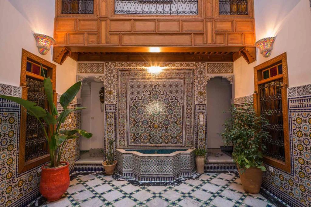 Cette grande chambre dispose de carrelage et d'un grand mur. dans l'établissement Riad Scalia Traditional Guesthouse Fes Morocco, à Fès
